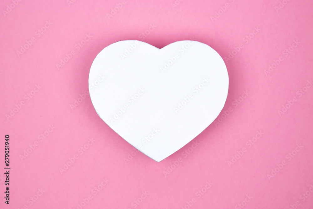 White heart shape gift box for holiday, christmas, thanks giving day, birthday top view isolated on pink background.