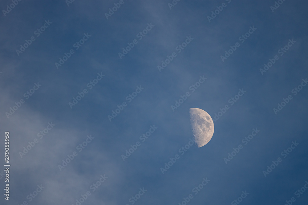 Moon in blue sky with few clouds Moon in blue sky with few clouds