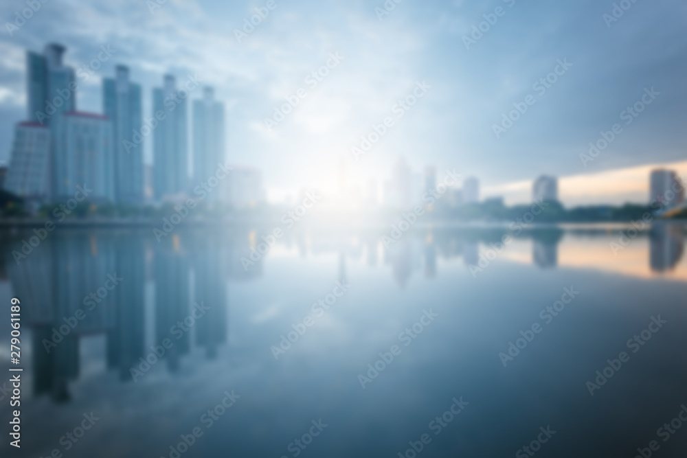 Blur City building with water reflection before sunset