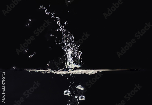 Explosion on water surface isolated on black background, close up view. Water bubbles underwater and in air, black background for overlays design, screen blending mode layer