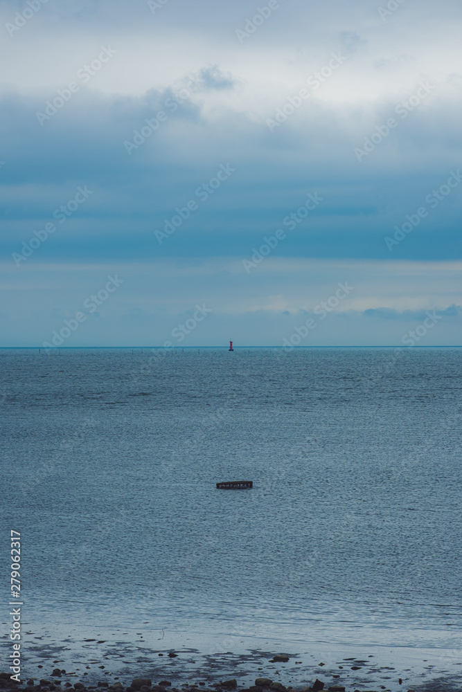  A lighthouse can be seen over cloudy sky A fishing net in the foreground