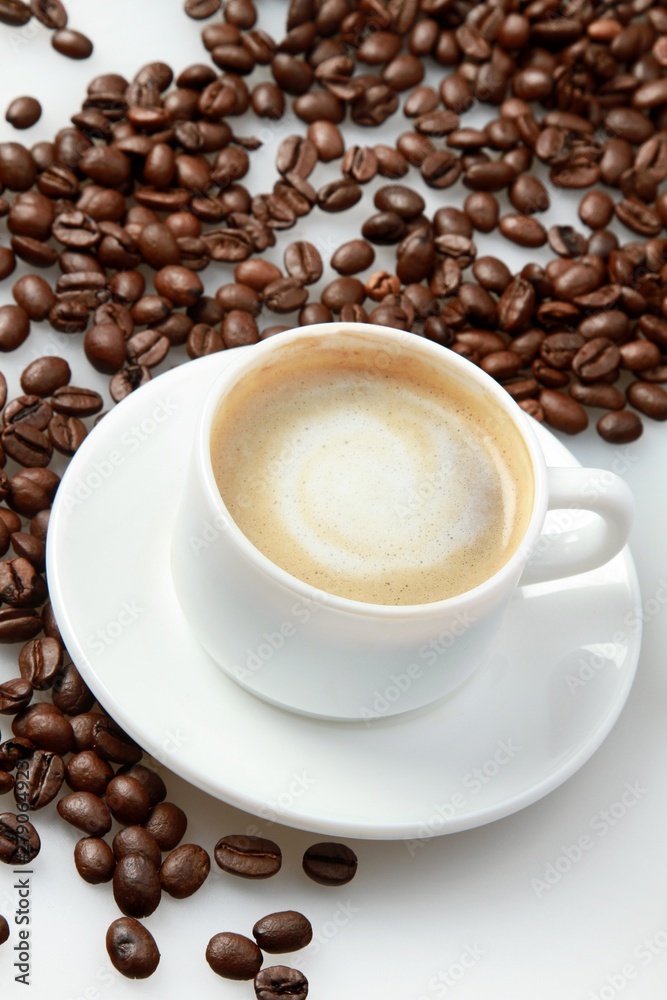 Cup of coffee surrounded by coffee beans Cup of coffee surrounded by coffee beans