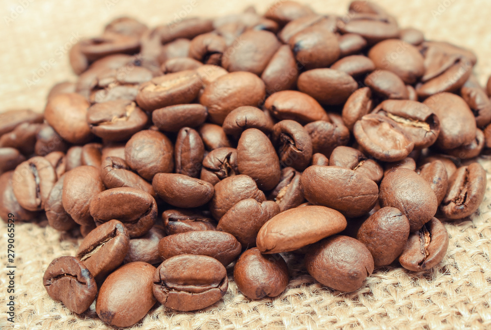 Heap of coffee grains on old jute burlap Heap of coffee grains on old jute burlap