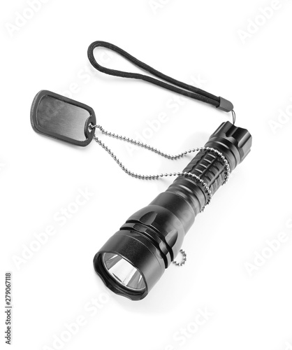 Modern flashlight and dog tag on white background