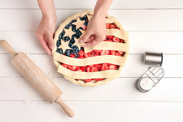 Woman making American flag pie in kitchen