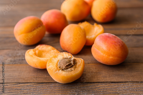 Tasty ripe apricots on wooden table