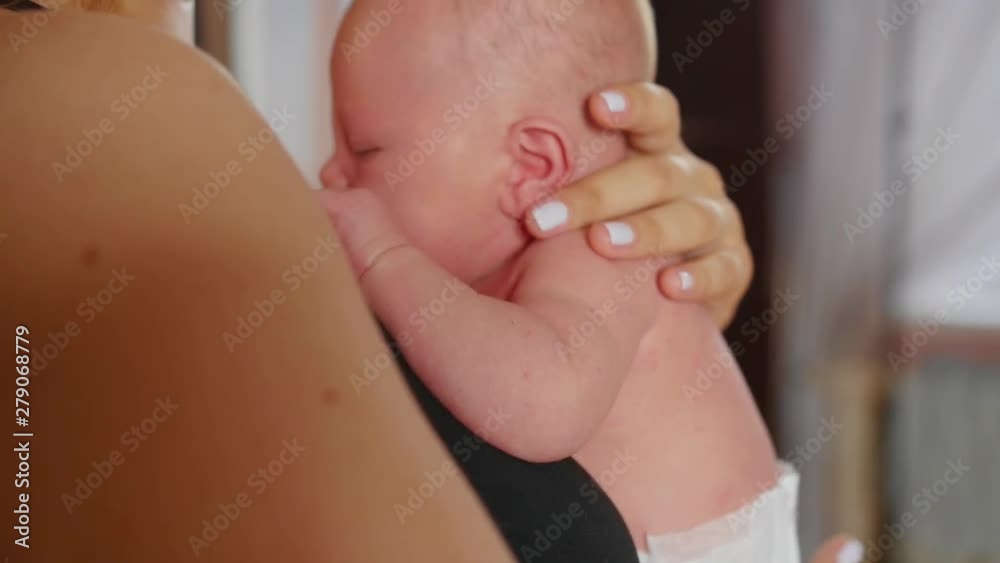 Close up view of a mother holding her nice newborn baby.