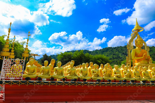 golden Buddha statue with among small 1,250 Buddha statue at Makha Bucha Buddhist memorial park located at nakhon nayok province, Thailand photo