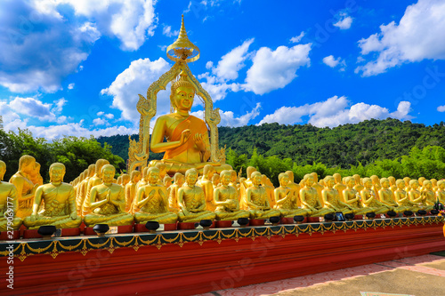 golden Buddha statue with among small 1,250 Buddha statue at Makha Bucha Buddhist memorial park located at nakhon nayok province, Thailand photo