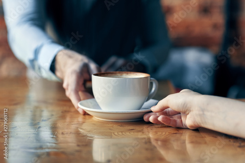 hands holding cup of coffee