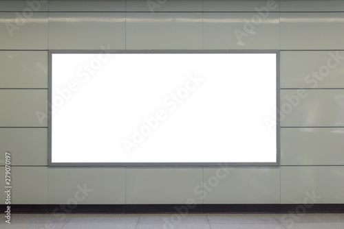 A clean, tidy subway station wall hangs a rectangular luminous blank billboard