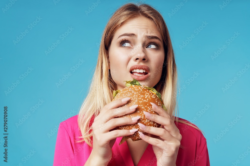 young woman eating sandwich