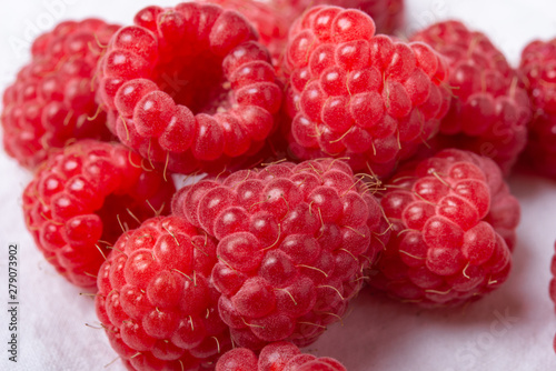Fresh red raspberries on white background. Close Up.