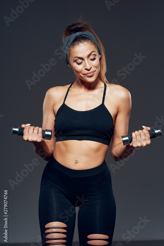 young woman exercising with dumbbells