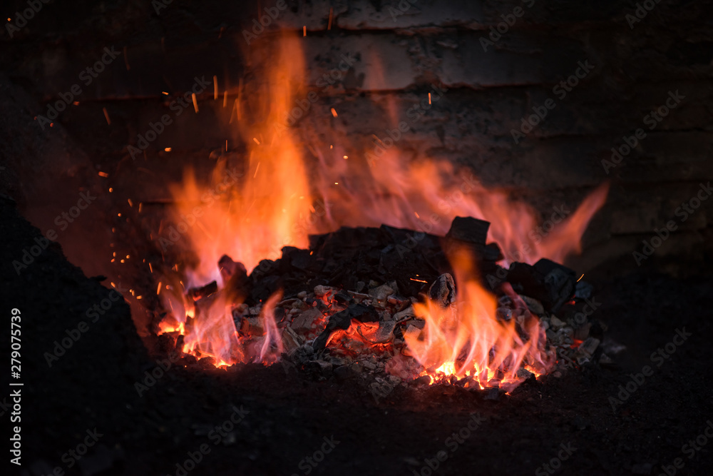 Traditional blacksmith furnace with burning fire Traditional blacksmith furnace with burning fire