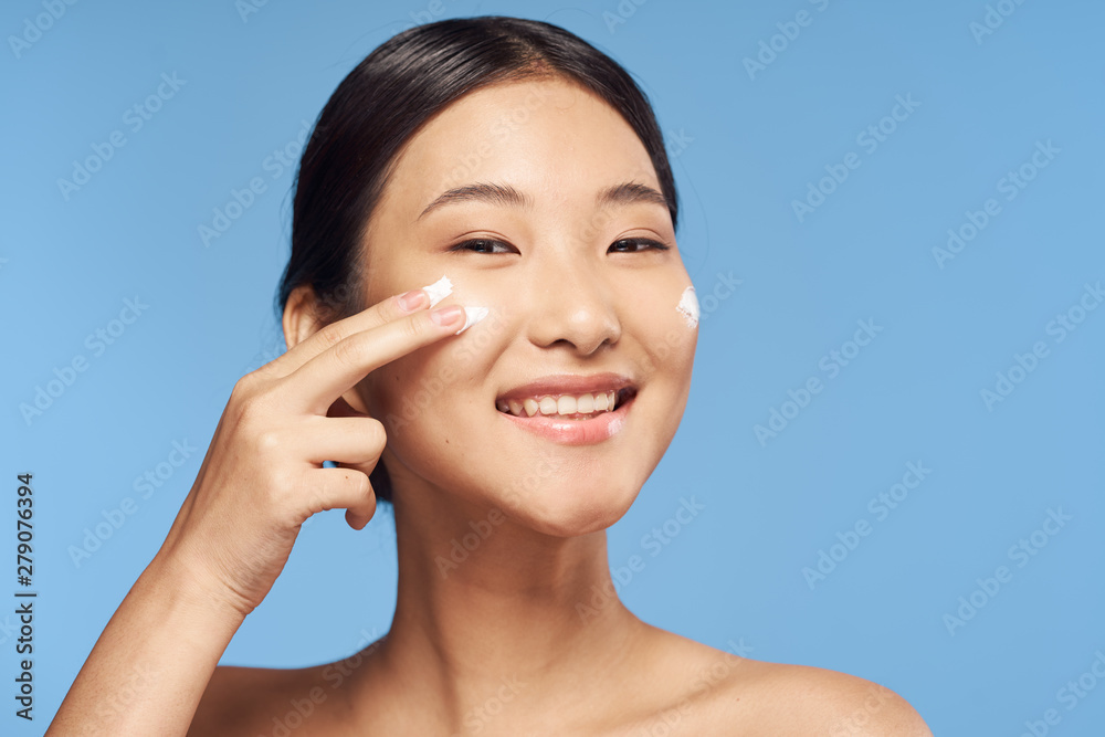 portrait of young woman applying blusher portrait of young woman applying blusher