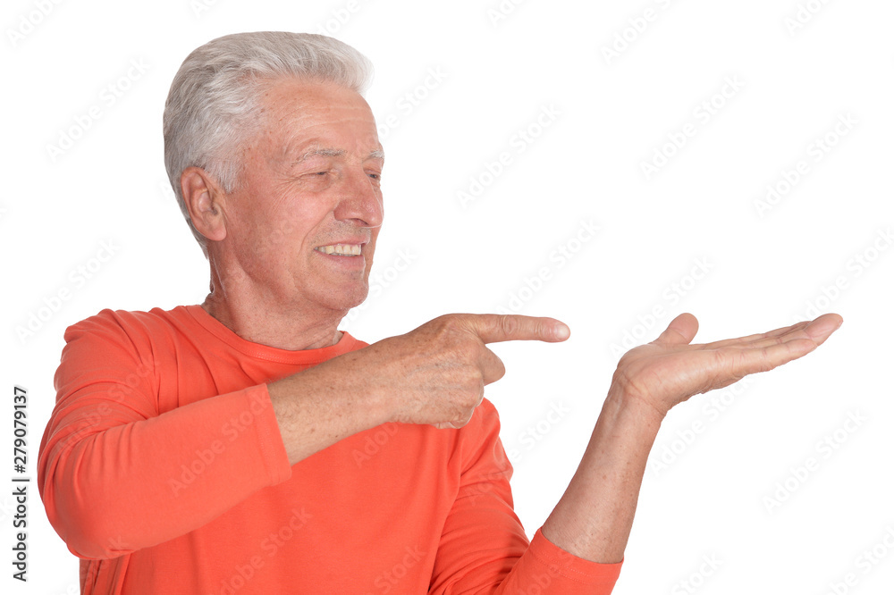 Happy senior man in orange sweater pointing
