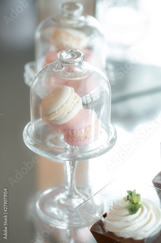 Gentle colorful macaroons in glass bell jar