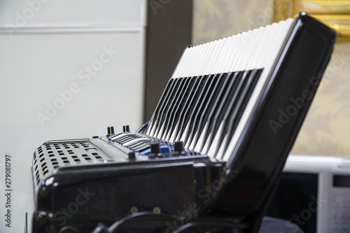 Keyboard accordion standing on the table. Selective focus