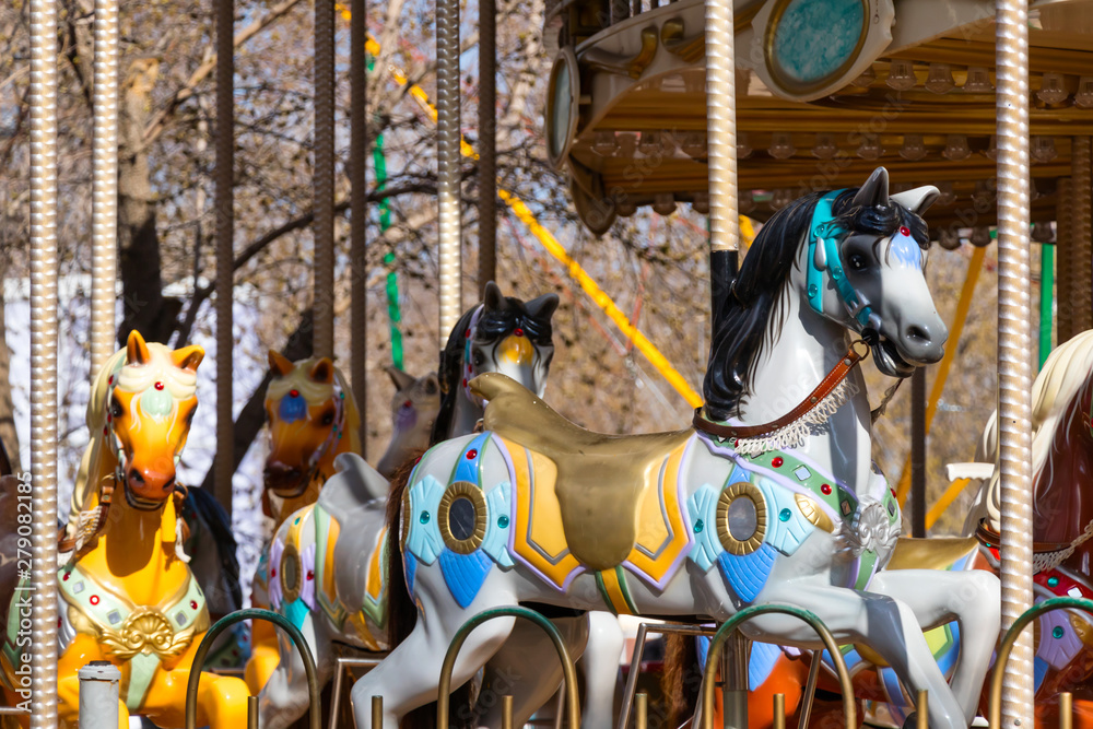 childrens toy horses carousel in the city park