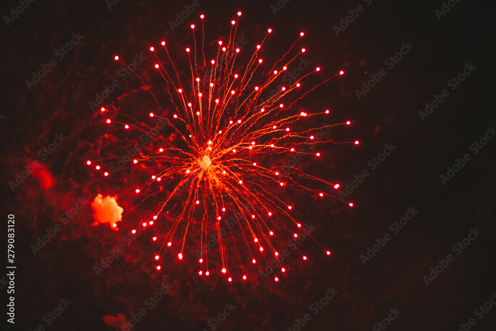 Close-up red and gold festive fireworks on a black background. Abstract holiday background Close-up red and gold festive fireworks on a black background. Abstract holiday background