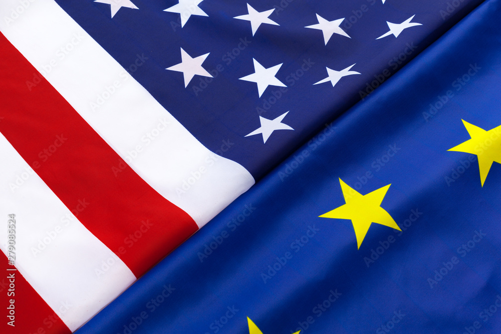 Closeup of Flags of USA and European Union lying together on table Closeup of Flags of USA and European Union lying together on table