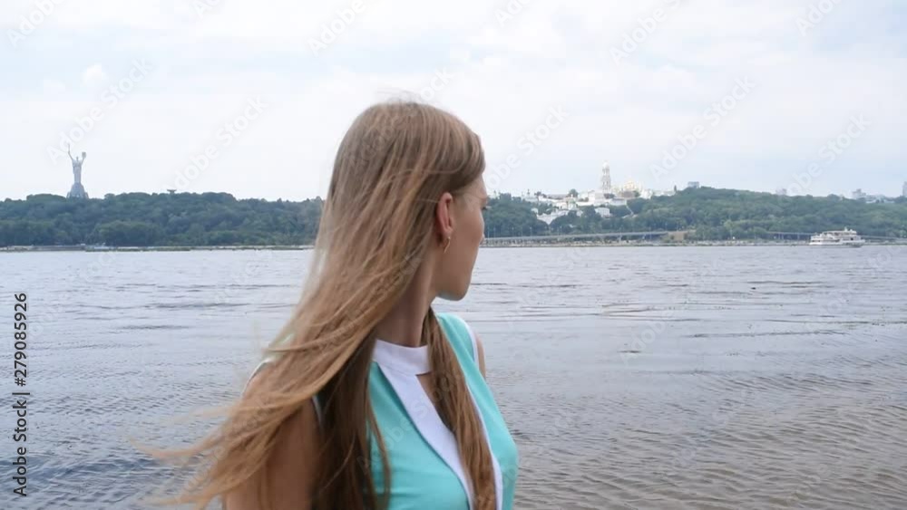 Portrait of a young girl near the river in the city. Portrait of a young girl near the river in the city.