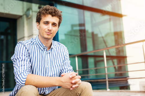 smart men standing in front of a building outside photo