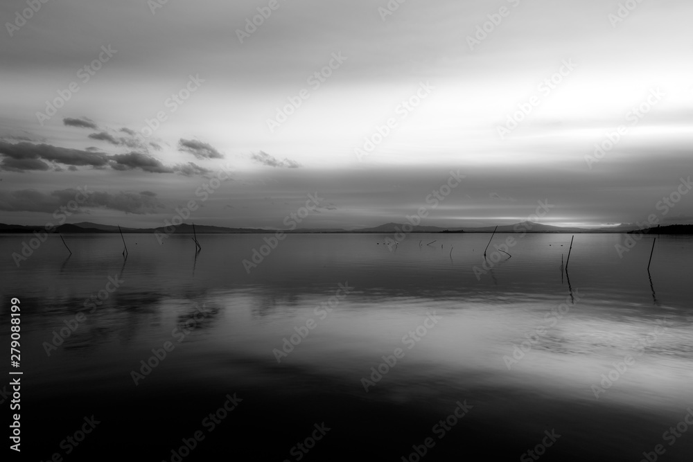 Beautiful and symmetric sunset over Trasimeno lake (Umbria, Italy) Beautiful and symmetric sunset over Trasimeno lake (Umbria, Italy)