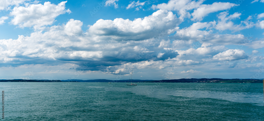 sailboat crossing Lake Constance on a beautiful summer evening