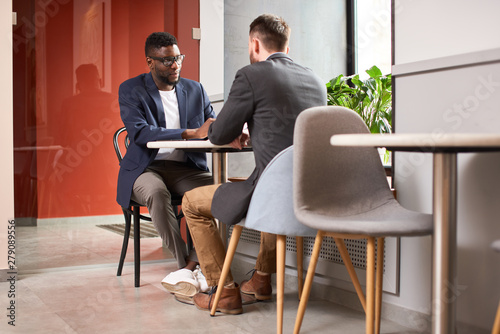 Two businessmen having a meeting in the cafe.