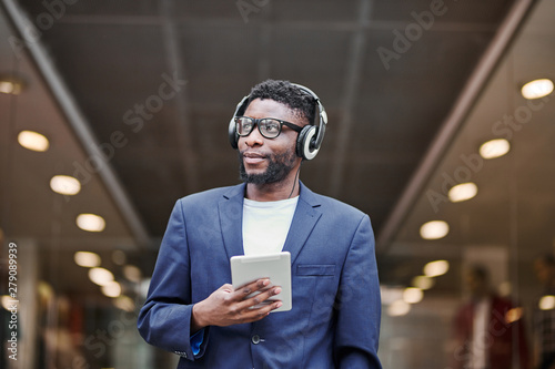 Man in headphones walking down the street.
