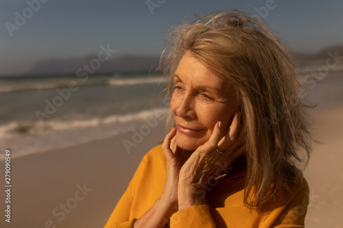 Senior woman standing on the beach
