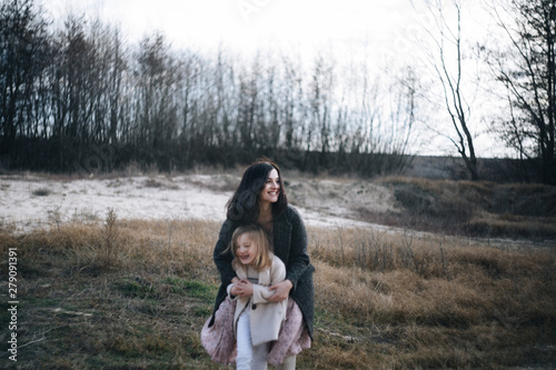 Mom and her daughter are playing and hugging outdoor photo