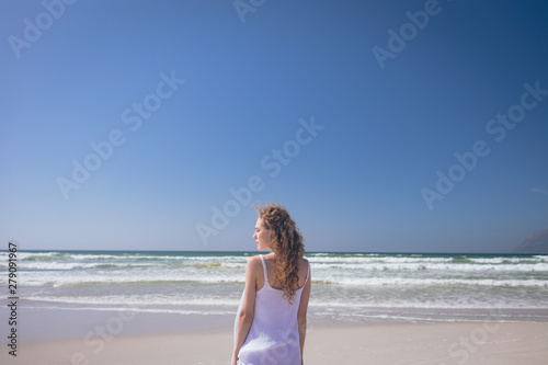 Young woman standing at beach on a sunny day