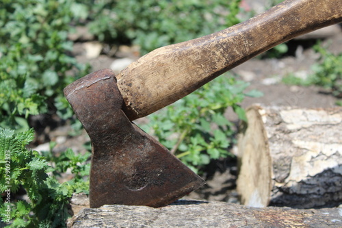 photo ax stuck in a log 