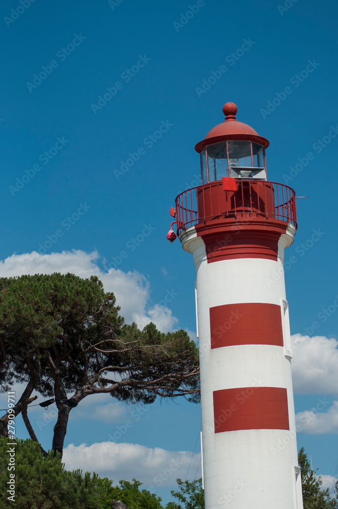 View of red lighthouse on cloudy sky background in La Rochelle -  France