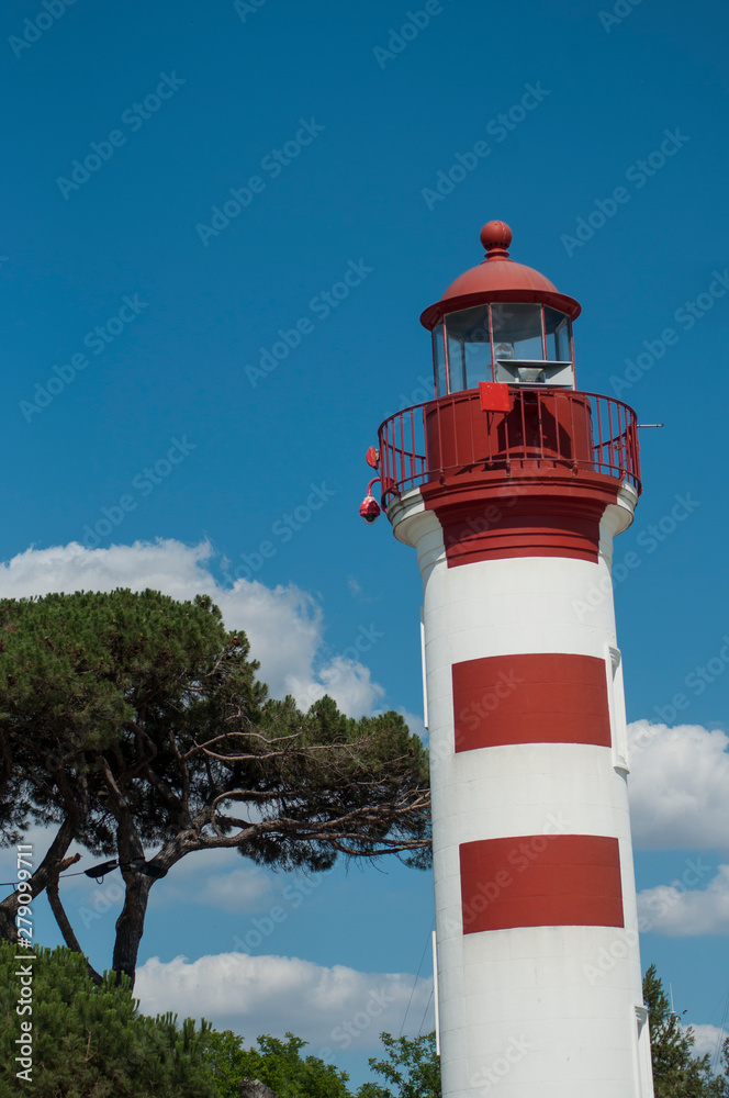 View of red lighthouse on cloudy sky background in La Rochelle - France View of red lighthouse on cloudy sky background in La Rochelle - France