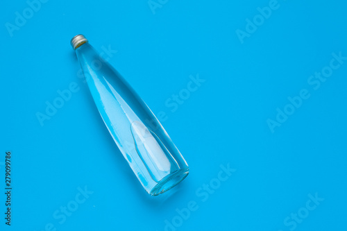 Blank water bottle on blue background top view