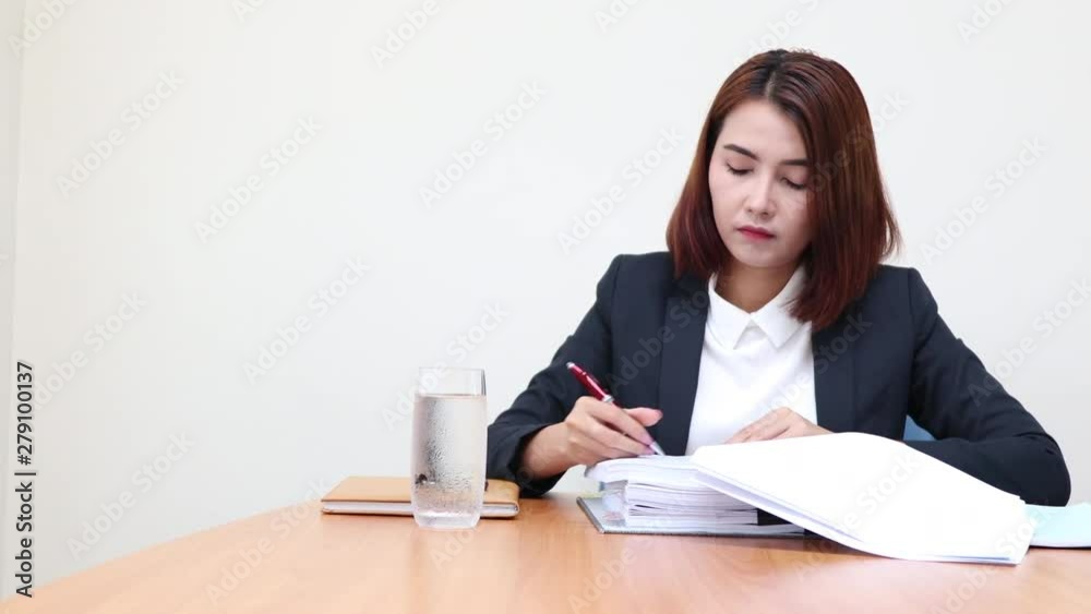 Portrait business woman working at the office and take notes. Portrait business woman working at the office and take notes.