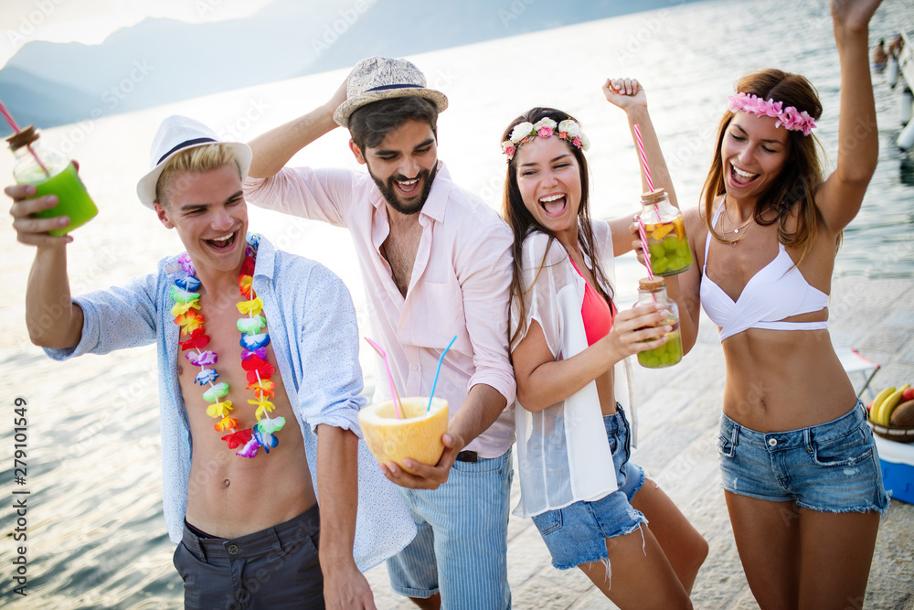 Group of friends enjoy on the beach on summer vacation