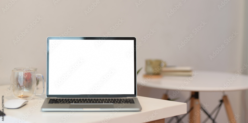 Minimal home office desk with blank screen laptop Minimal home office desk with blank screen laptop