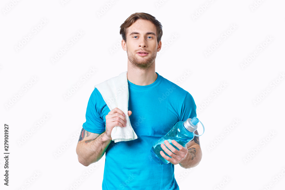 portrait of young man holding bottle of water