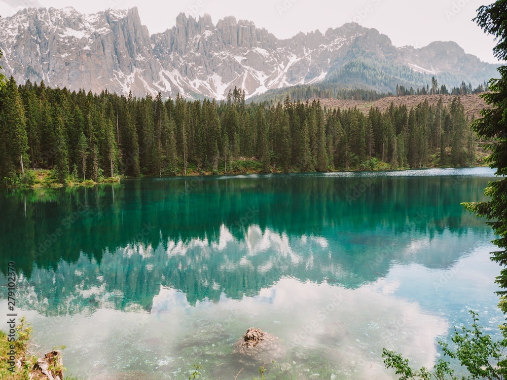 Karersee (Lago di Carezza), is a lake in the Dolomites in South Tyrol, a romantic beautiful place, azure pure water. Mountain summer landscape in the Dolomites in Northern Italy.