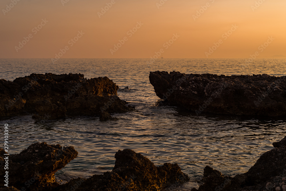 Beautiful sunset with rocks in the Adriatic sea, Dingac Borak, Dalmatia, Croatia, Peljesac peninsula