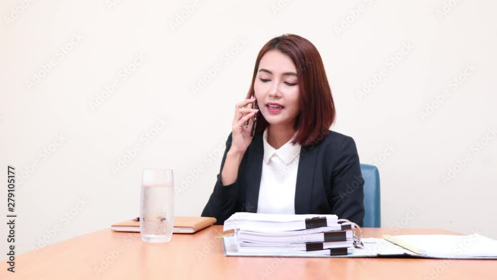 Portrait smiling business woman working at the office Talking on the phone with customers and take notes. Portrait smiling business woman working at the office Talking on the phone with customers and take notes.