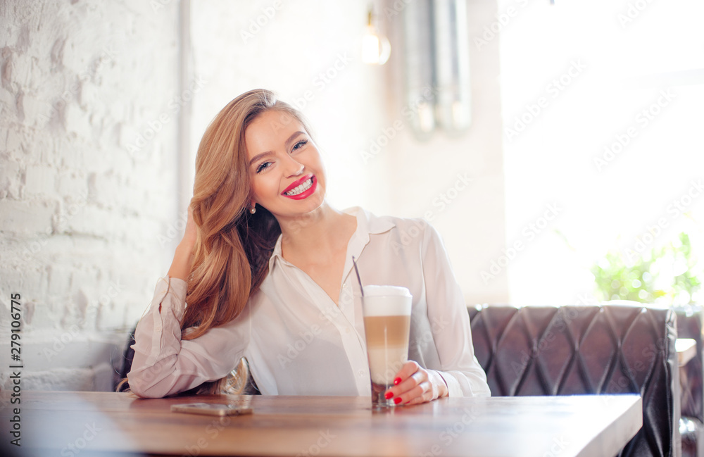 Young woman holding cup of coffee. Young woman holding cup of coffee.