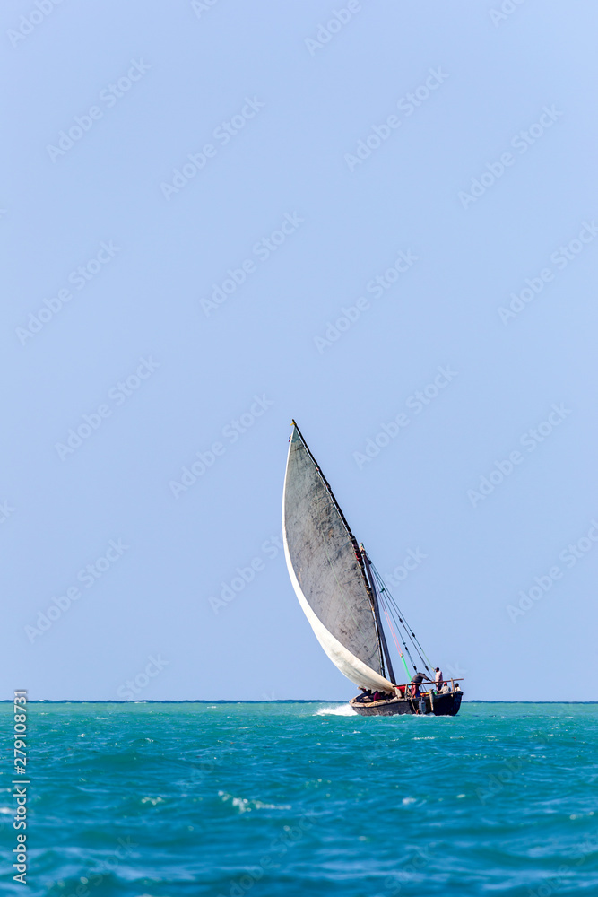transport dhow seen from a distance showing open ocean and flat horizon transport dhow seen from a distance showing open ocean and flat horizon