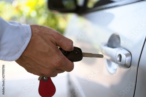 The new car owner is opening the car door.