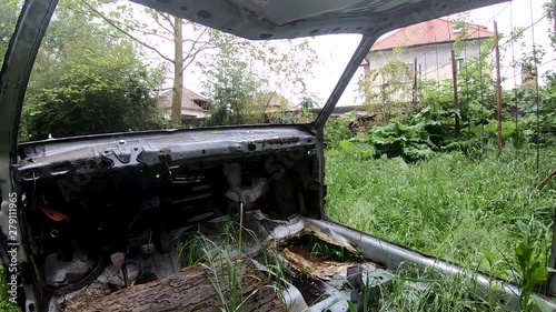 SLOWMO left pan view of a ruined car photo